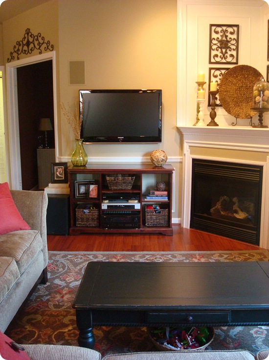 TV cabinet next to corner fireplace